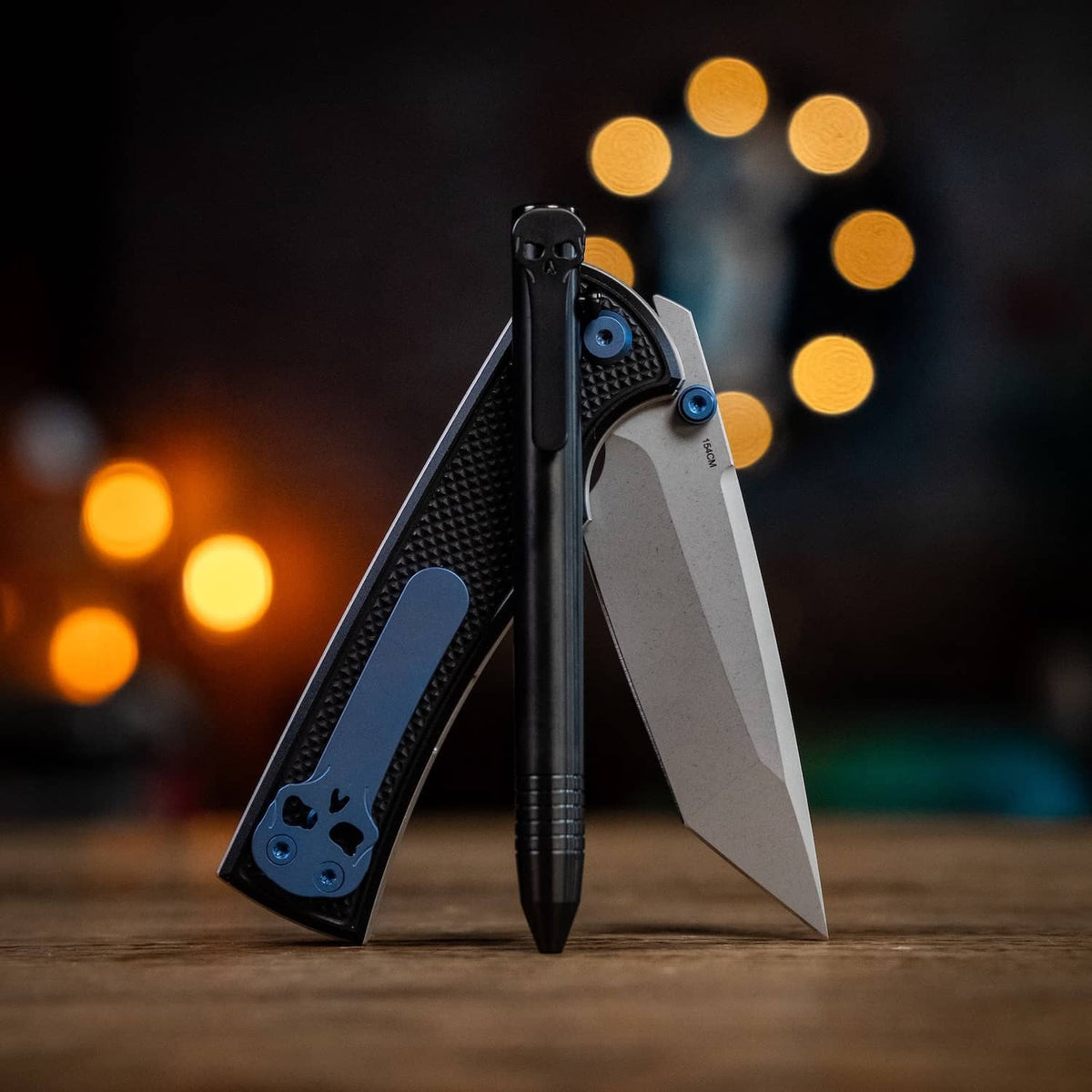 Chaves pens and knife set showcasing sleek designs in black and silver on a rustic background