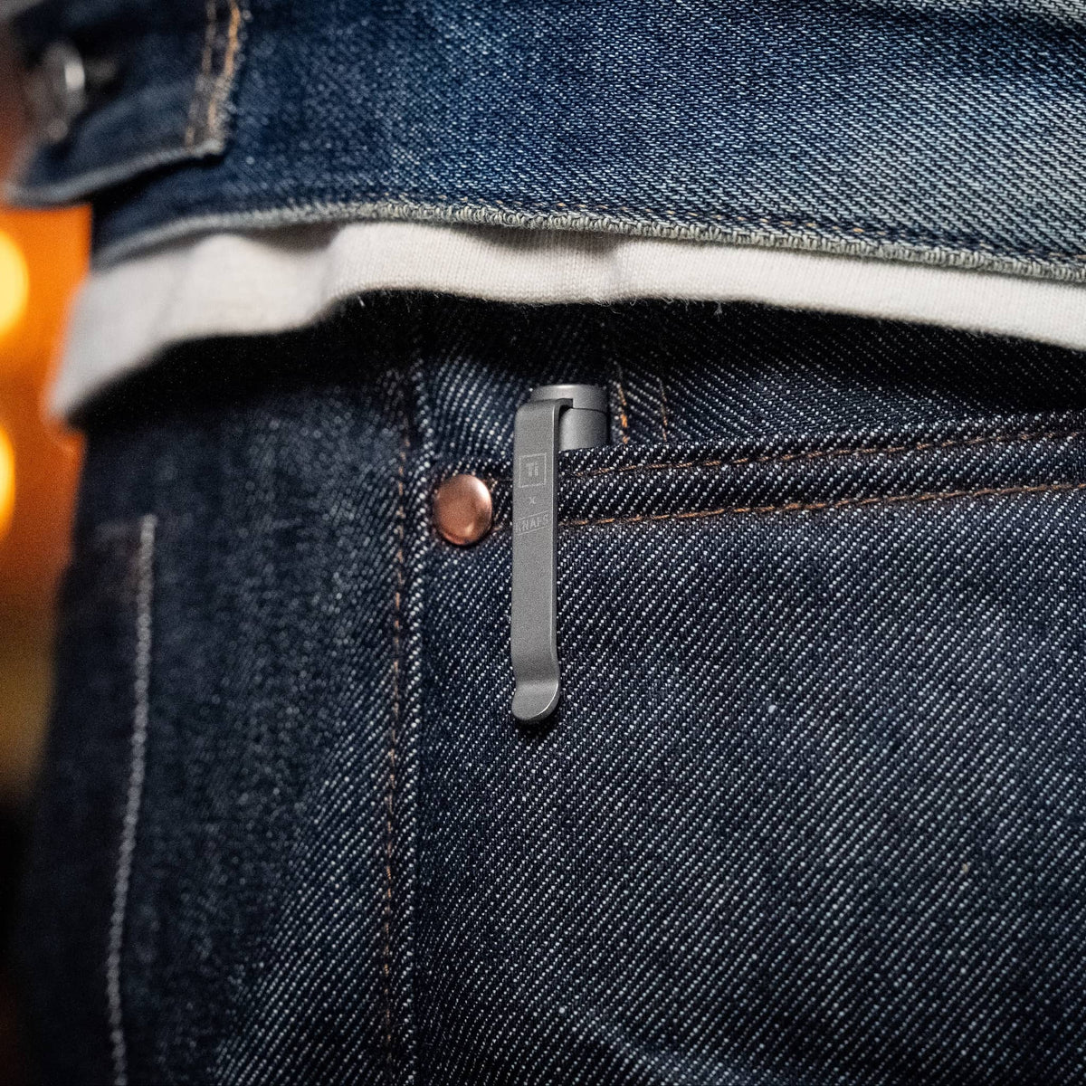 Knafs multi tool pen in matte gray clipped to a pocket, showcasing its compact design and sleek finish