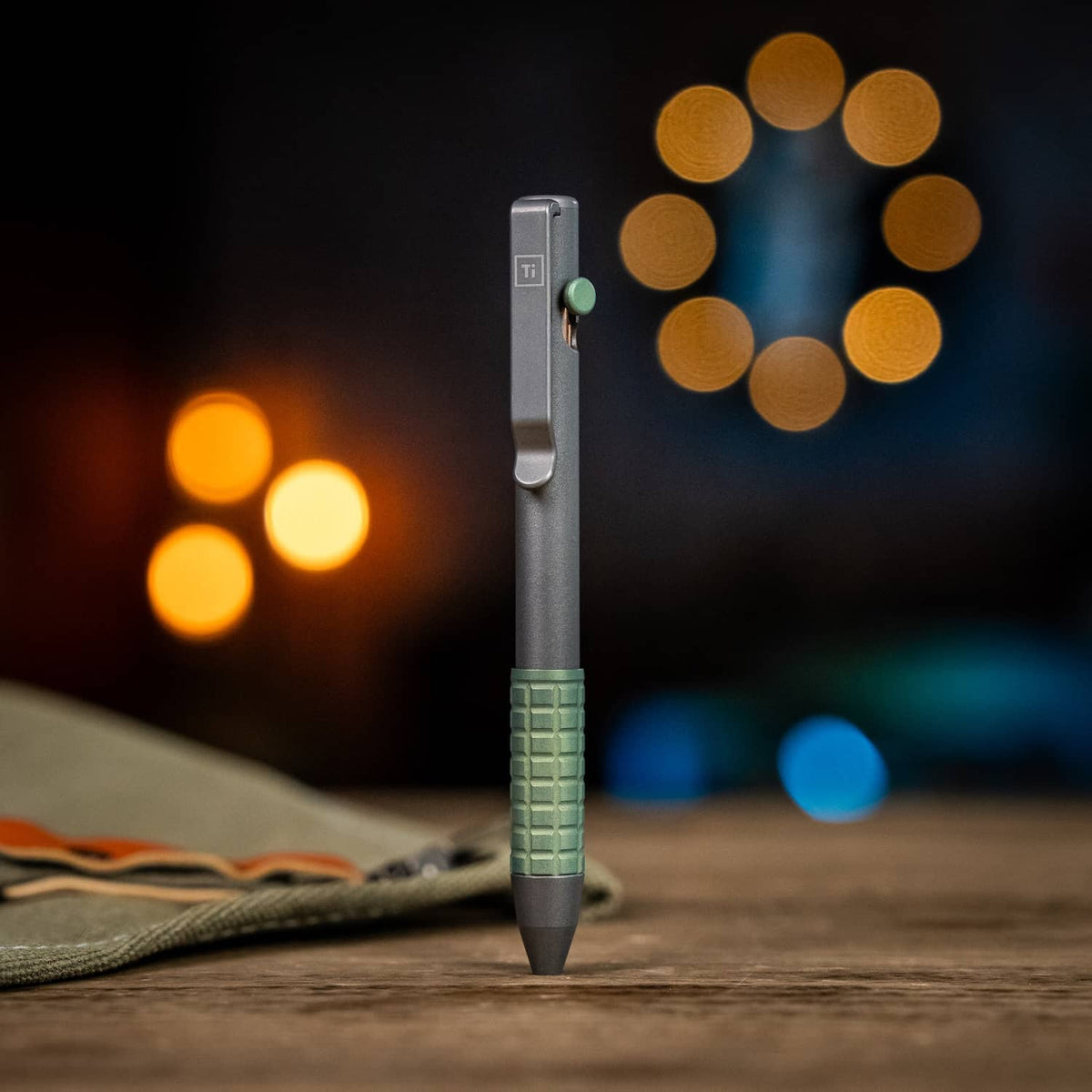 McNeese Pen in gray and green with textured grip, standing upright on a wooden surface