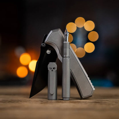 Chaves pens in gray titanium with a knife, showcasing a sleek design and detailed craftsmanship