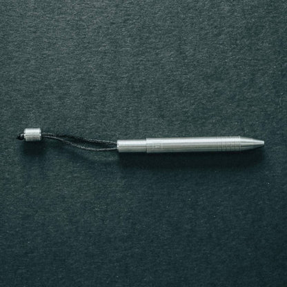 Big Idea Design LLC EDC titanium mini pen with sleek metallic finish and attached lanyard