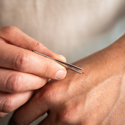 Knafs multi tool pen in stainless steel finish held in hand for precise tasks