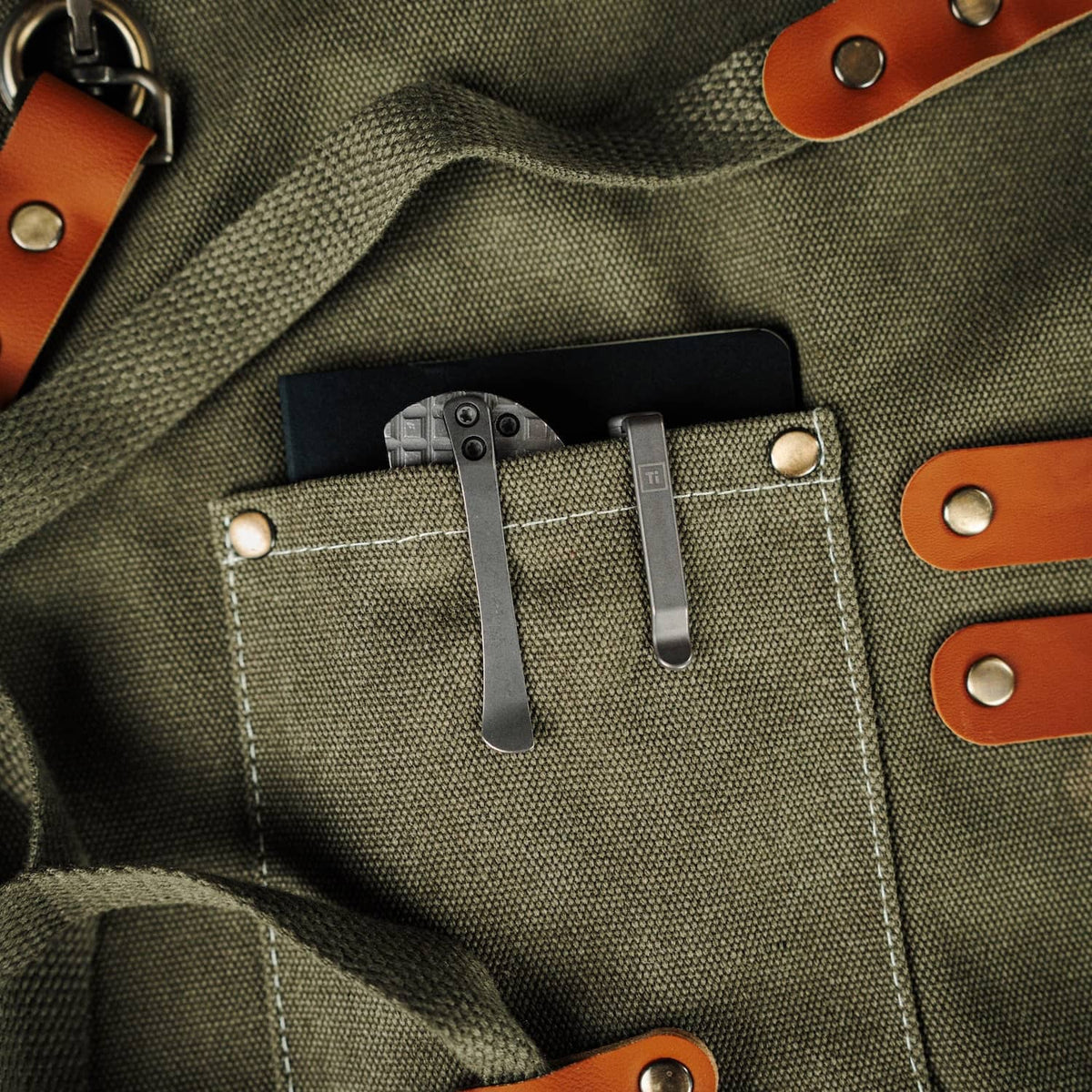 McNeese Pen in a pocket of an olive green canvas bag with brown leather straps